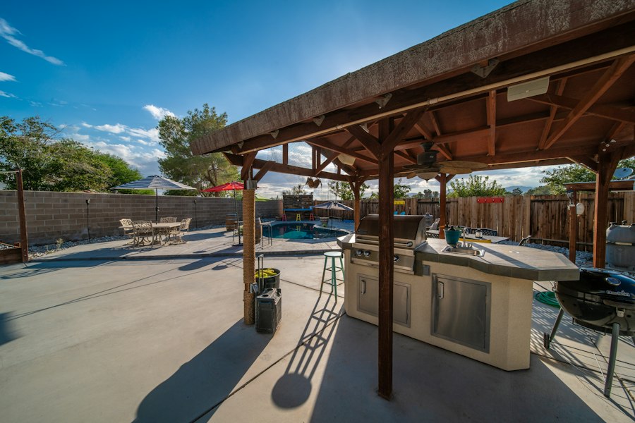 Outdoor kitchen beneath a covered patio